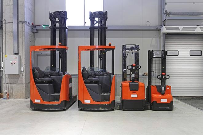 forklift operators maneuvering through a warehouse